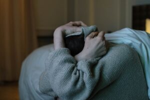 photo of a person covering her head with her sweater